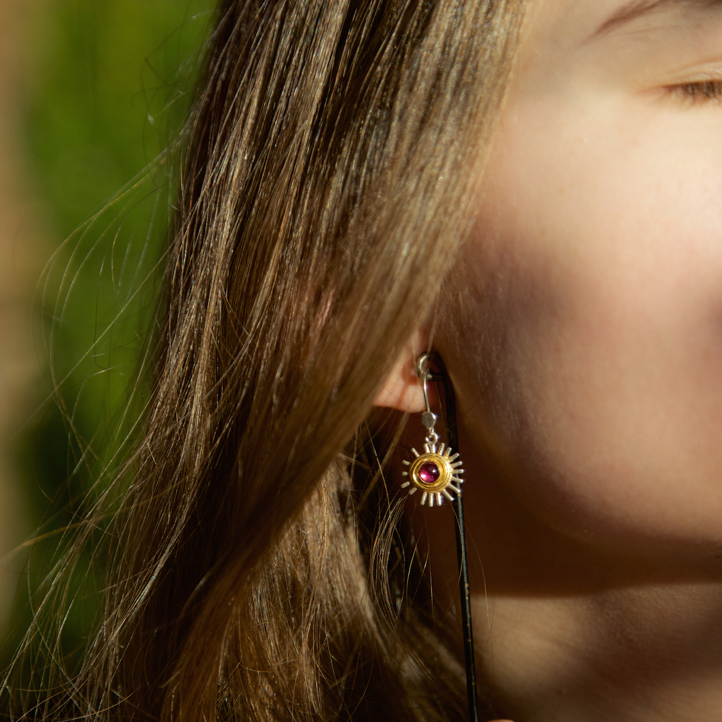 silver drop earrings with gold vermeil details, garnet stone in the centre. based on the Feverfew flower