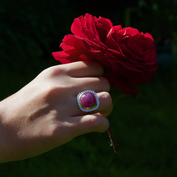 Berry red ruby ring – 1 Berry red ruby ring, silver with gold settting worn on models hands