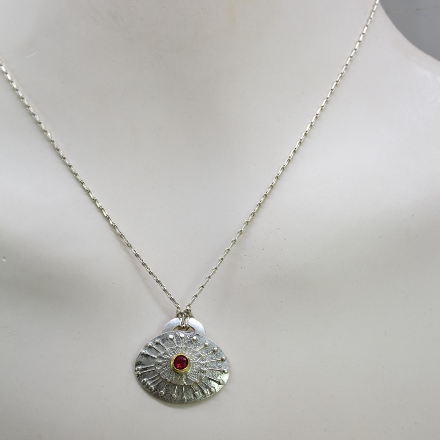 Pink gold silver pendant on silver chain on white bust